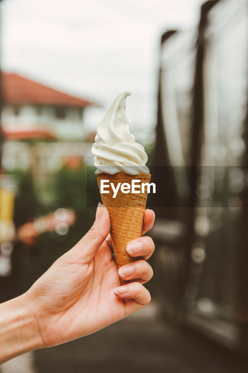 Cropped hand of woman holding ice cream cone