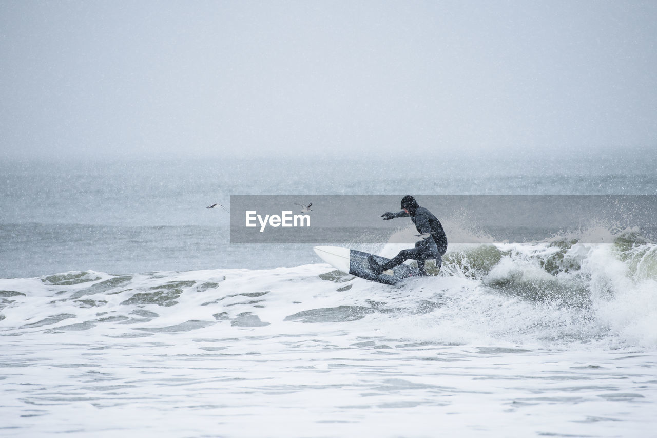 Man surfing during winter snow