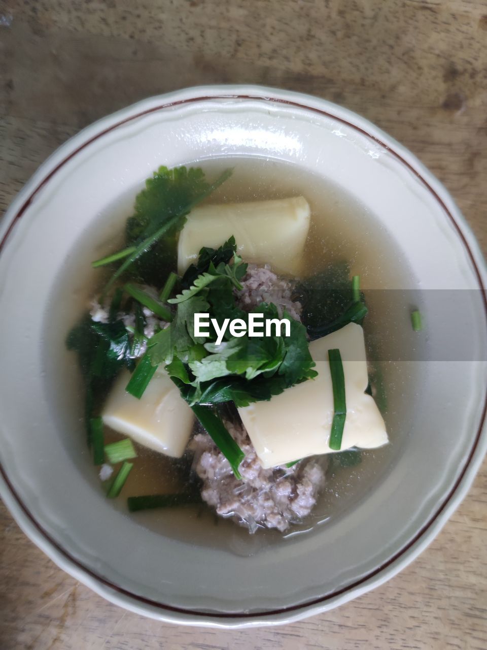 food and drink, food, healthy eating, dish, wellbeing, vegetable, freshness, indoors, herb, bowl, soup, high angle view, no people, cuisine, produce, directly above, garnish, table, wood, meal