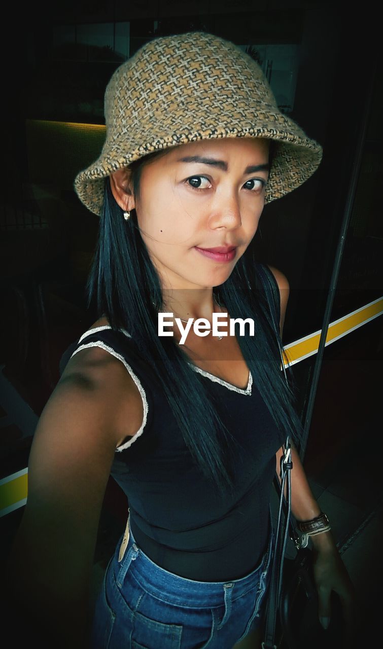 Portrait of woman wearing hat at home