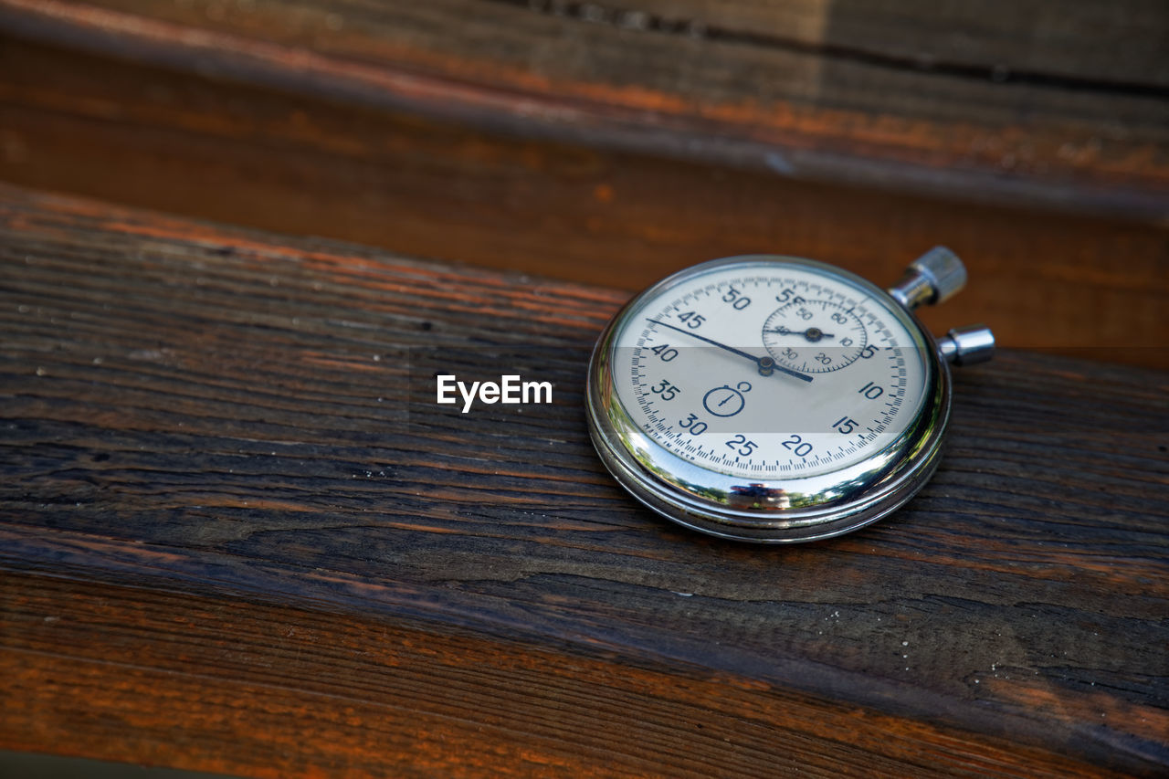 High angle view of stopwatch on wood