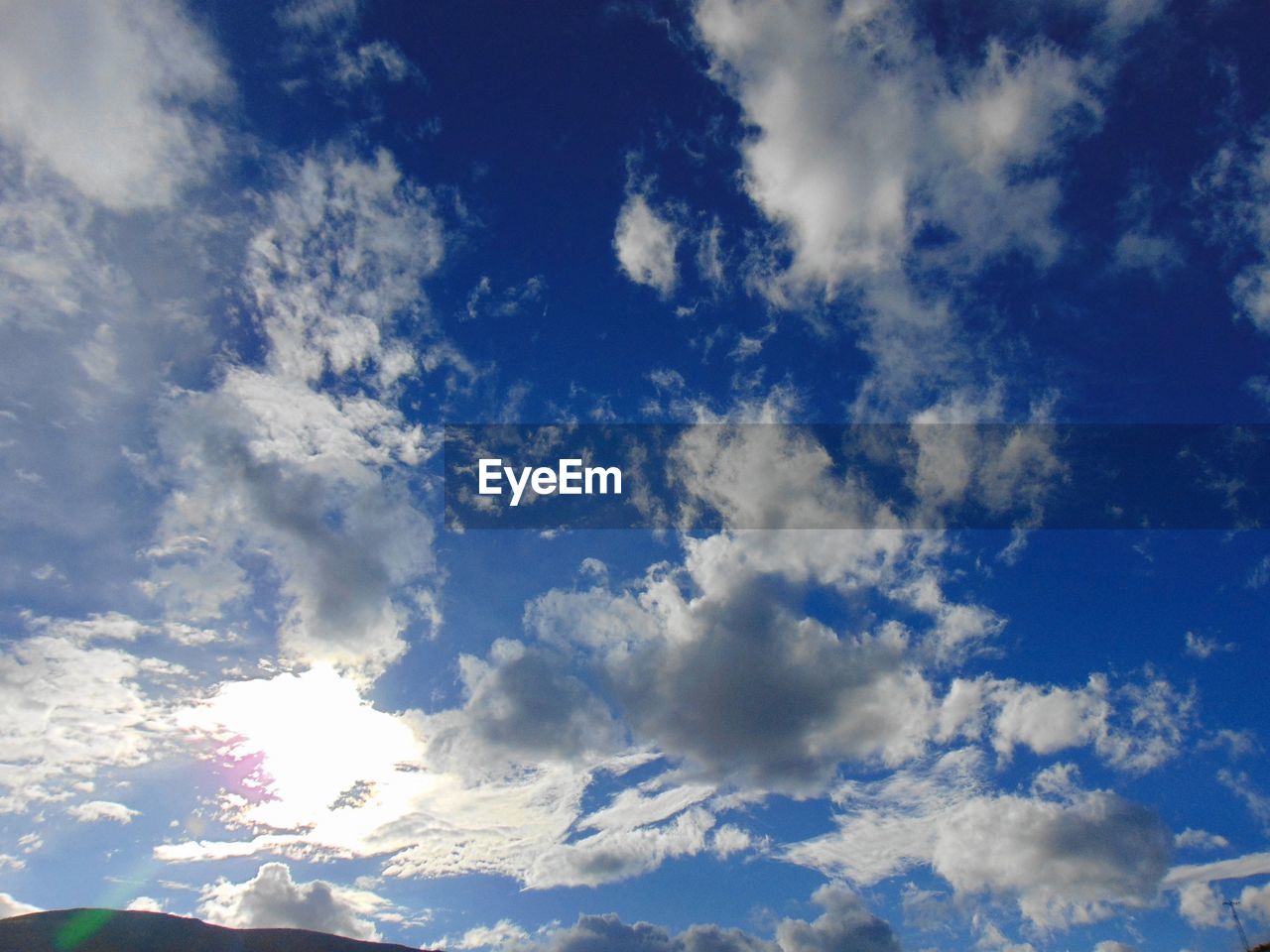 Low angle view of cloudy sky on sunny day