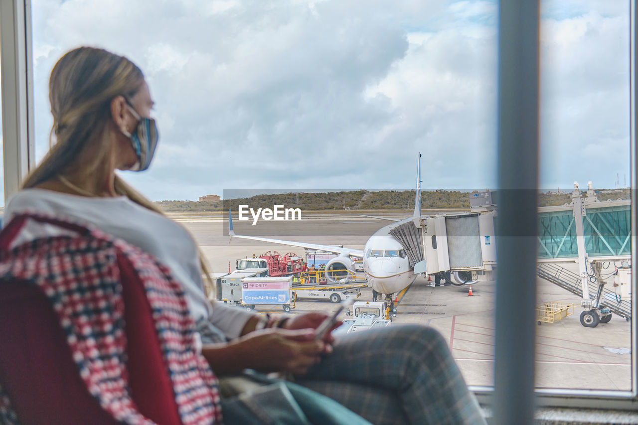 Young woman waiting to board the plane in the lounge the simon bolivar airport