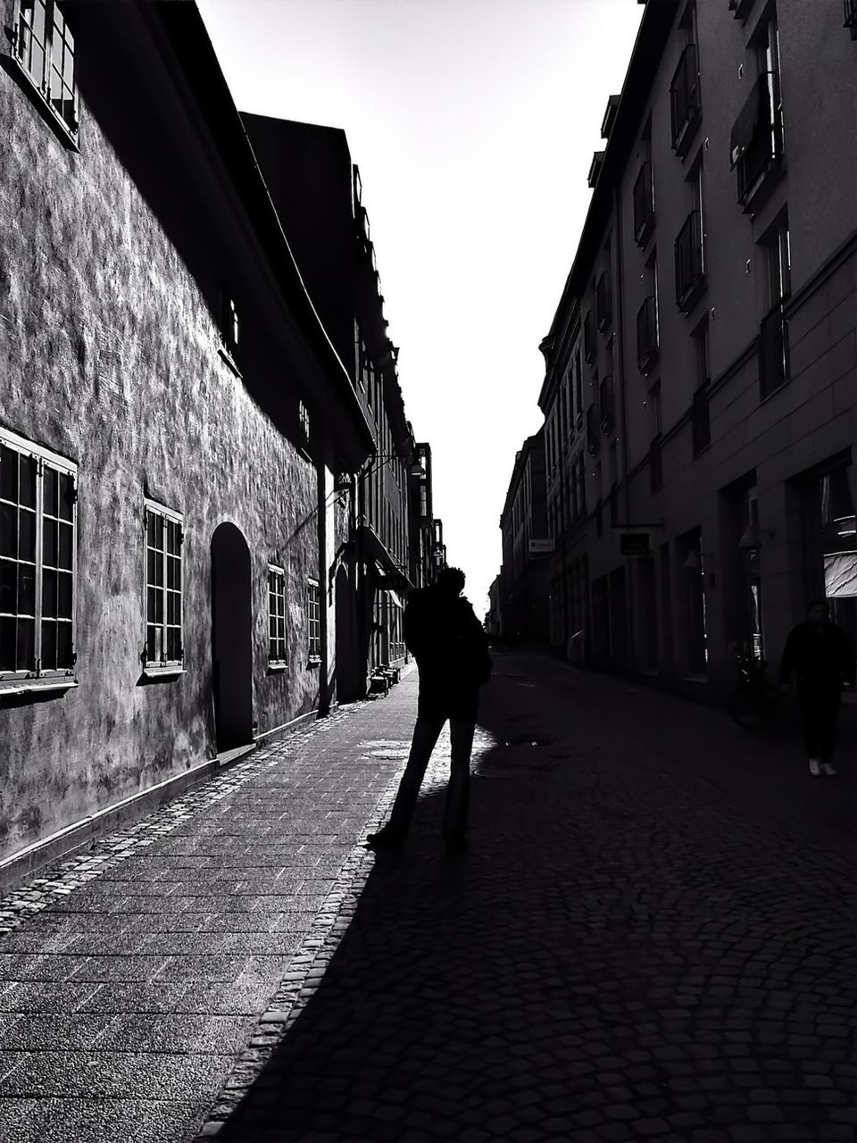 Silhouette man standing on street