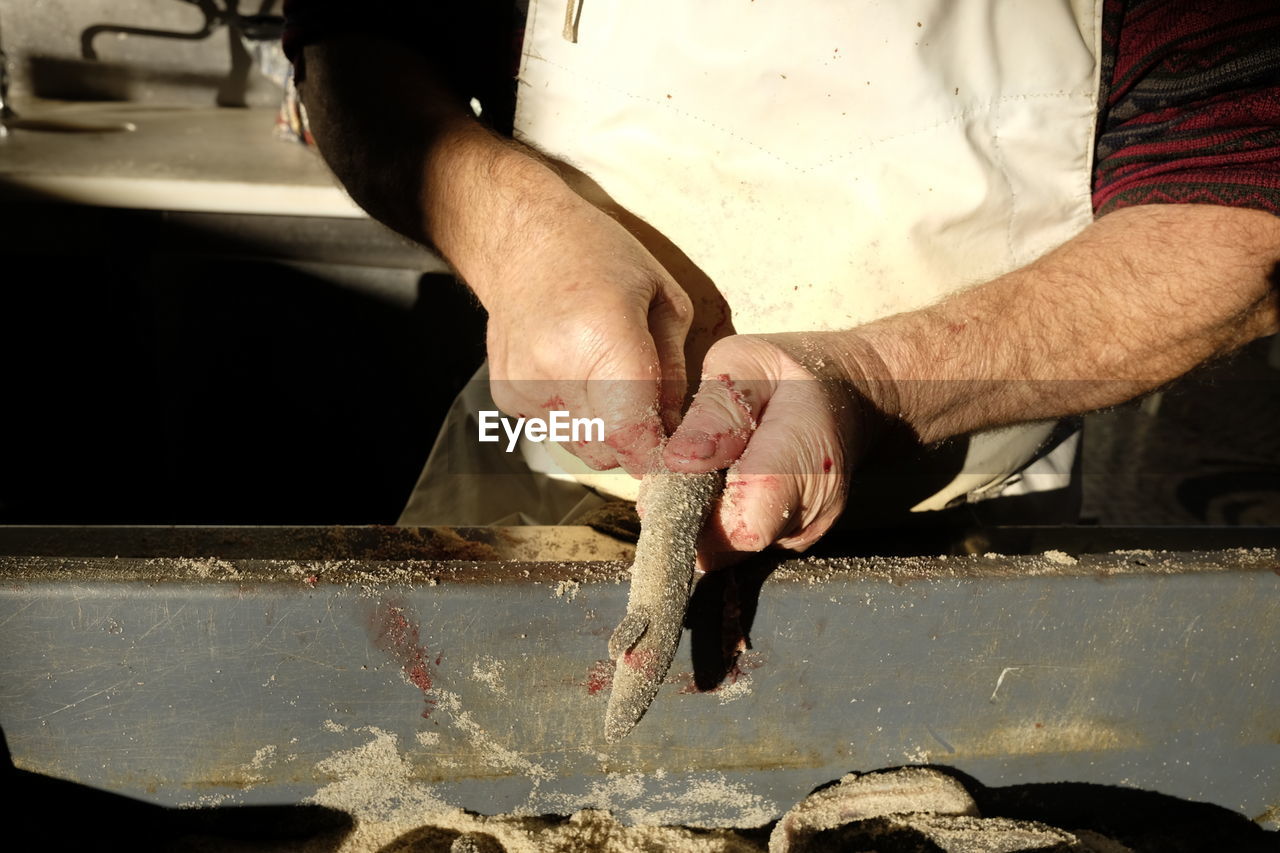 Midsection of man preparing food