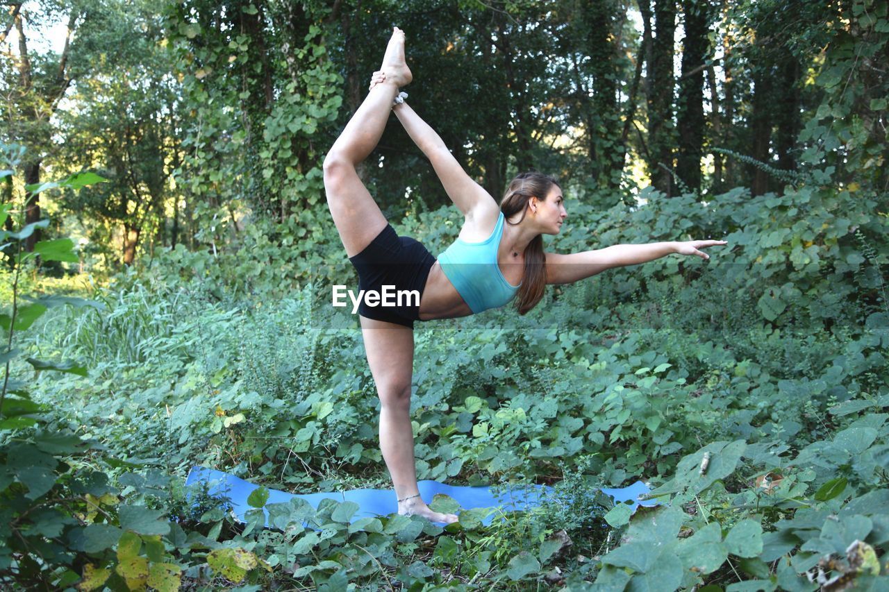Young woman exercising in forest