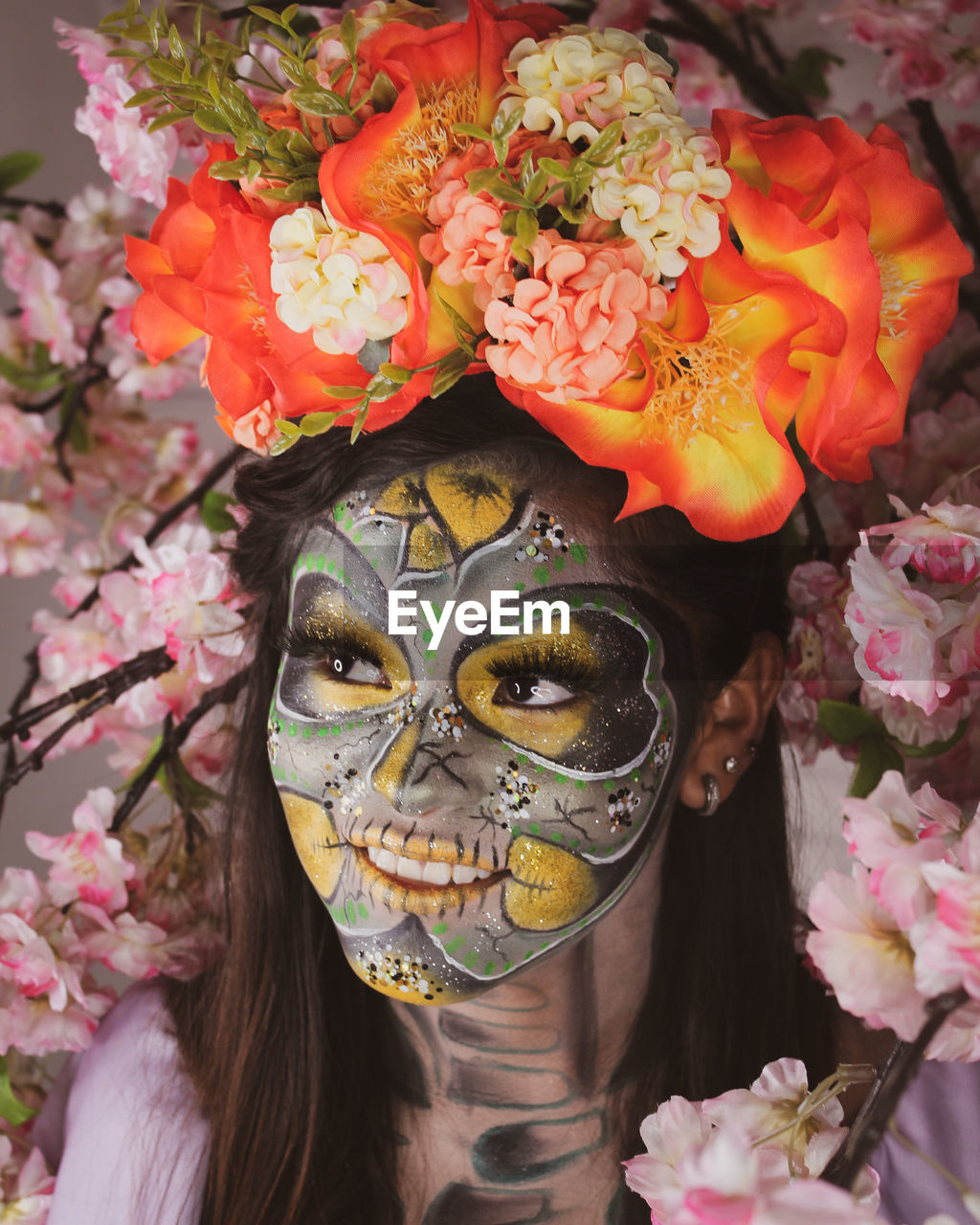 CLOSE-UP PORTRAIT OF WOMAN WITH PINK FLOWERS IN BLOOM