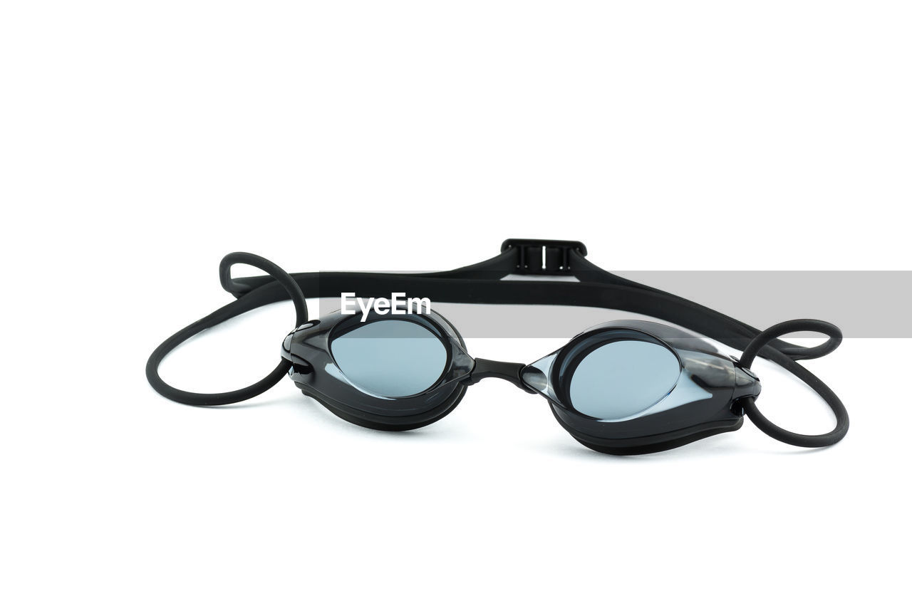 Close-up of swimming goggles over white background