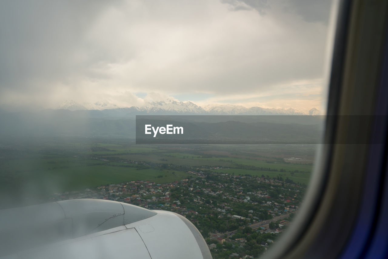 VIEW OF LANDSCAPE THROUGH AIRPLANE WINDOW