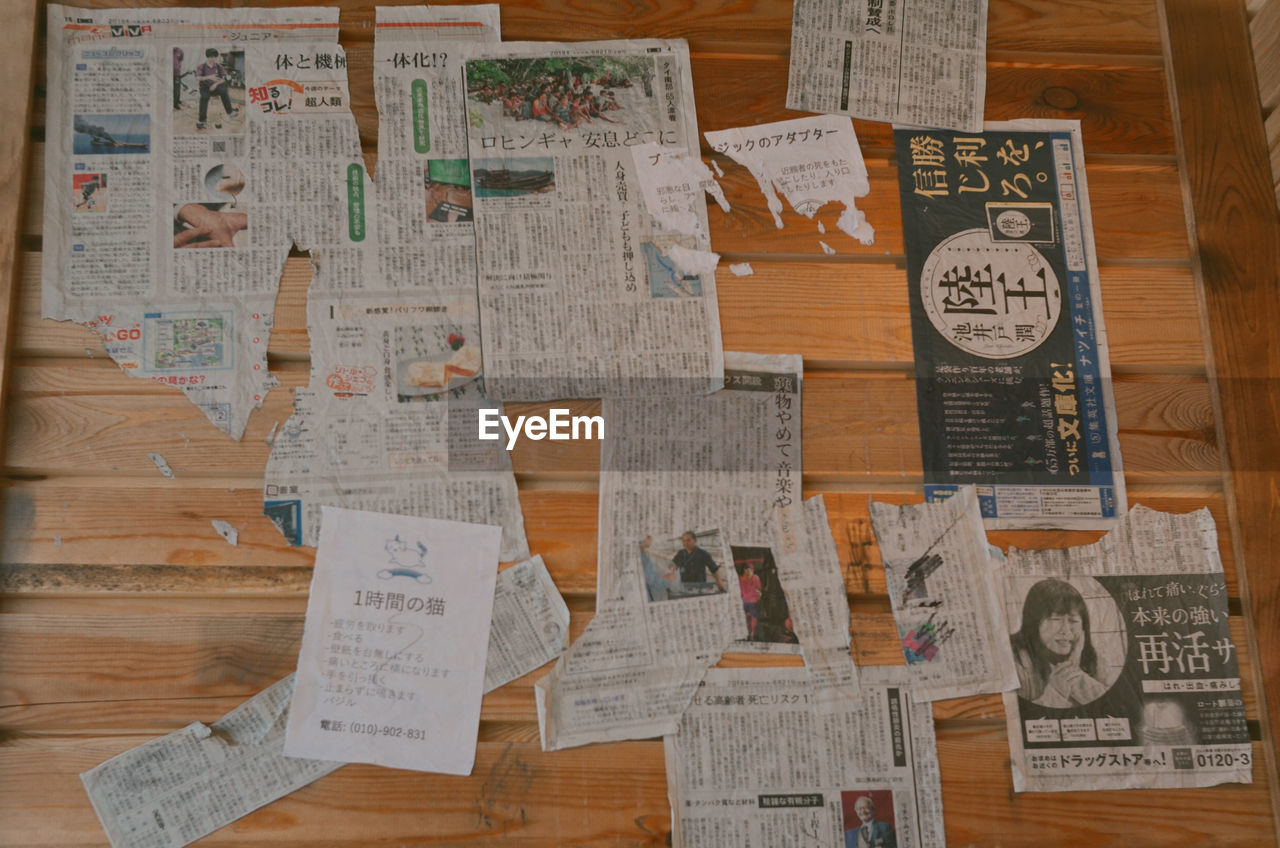 TEXT WRITTEN ON PAPER WITH WOODEN TABLE