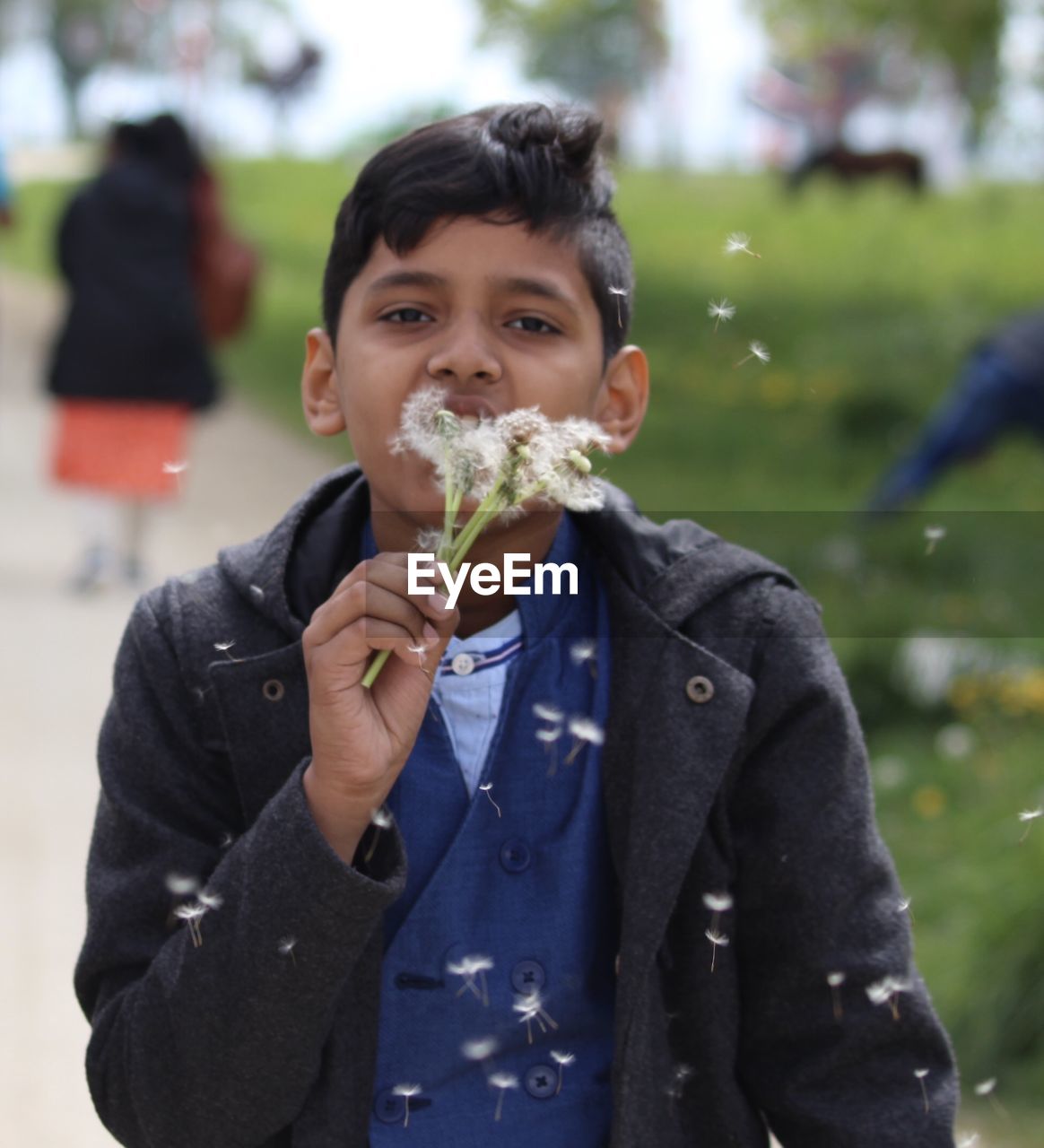 Portrait of boy blowing dandelions