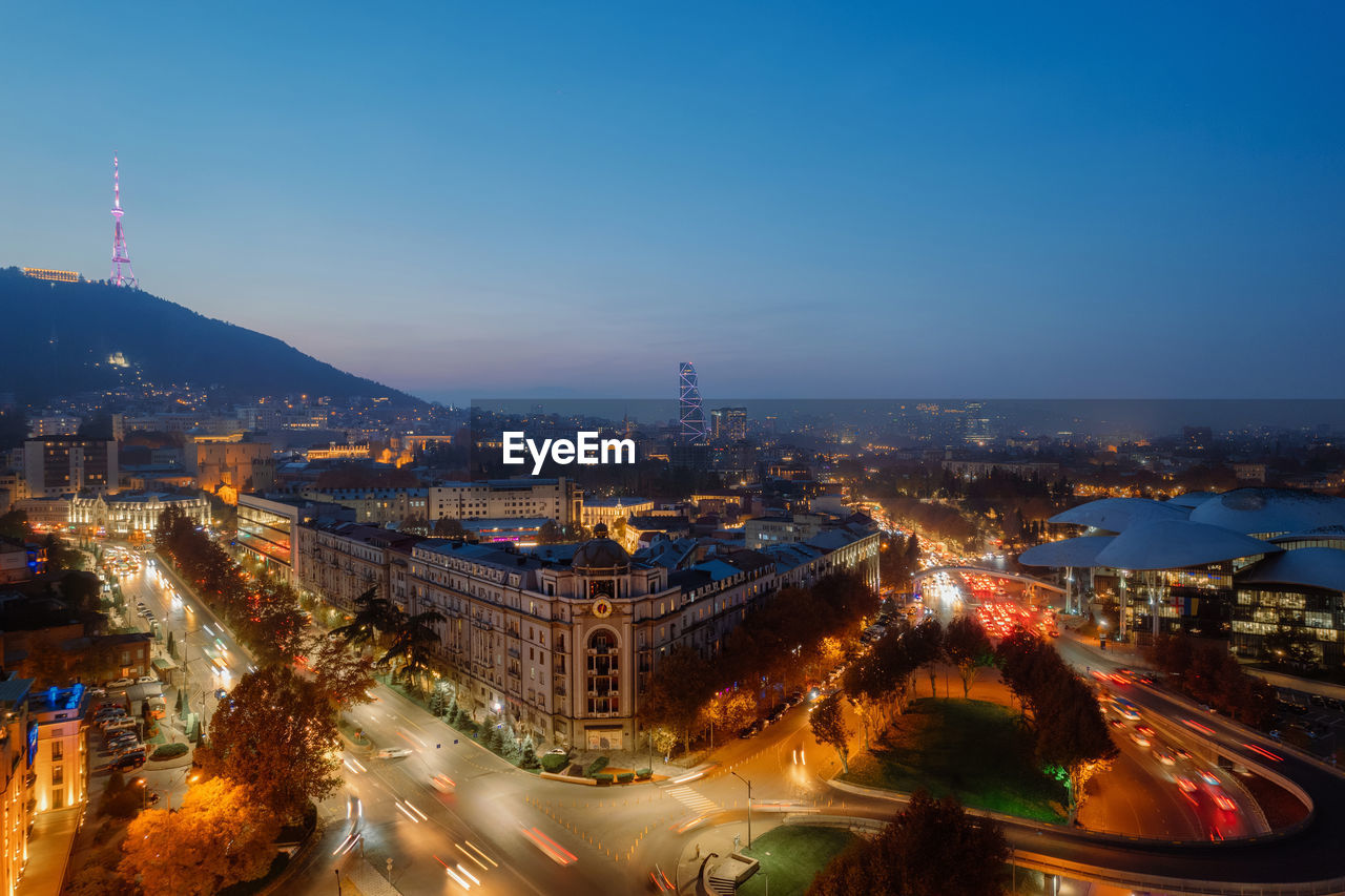 high angle view of illuminated cityscape against sky