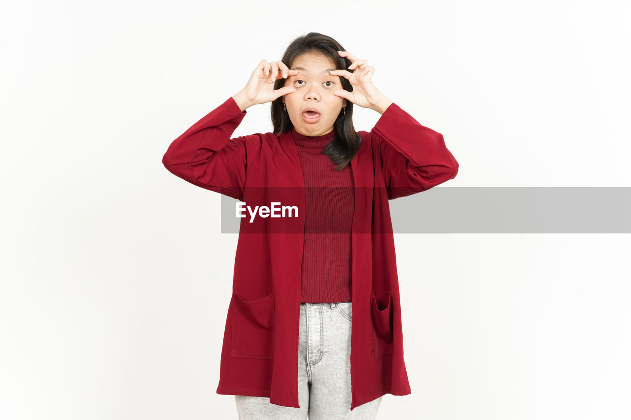 one person, white background, red, studio shot, outerwear, clothing, maroon, indoors, adult, emotion, women, portrait, hand, front view, child, hood, female, cut out, childhood, copy space, sleeve, standing, happiness, negative emotion, facial expression, person, young adult, costume
