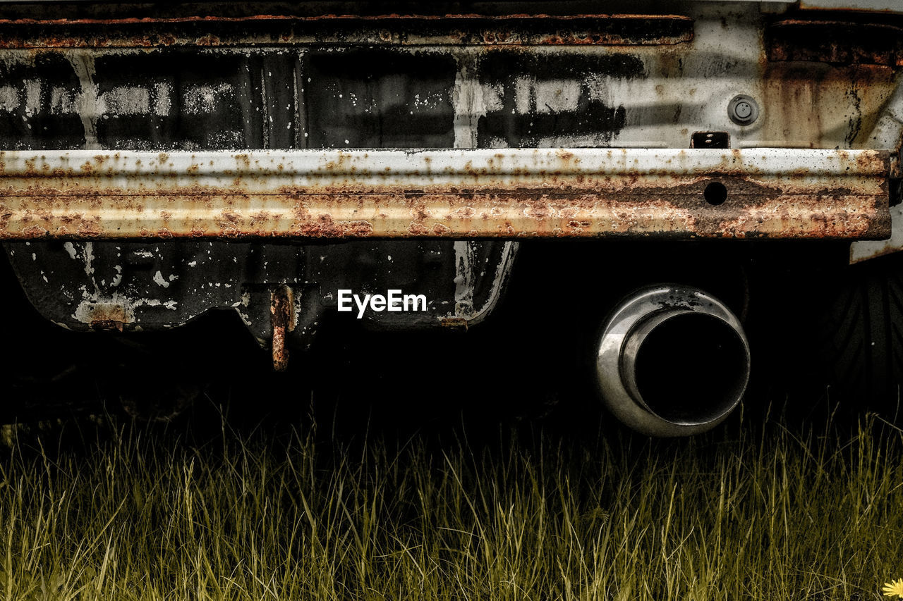 Close-up of rusty car on grass