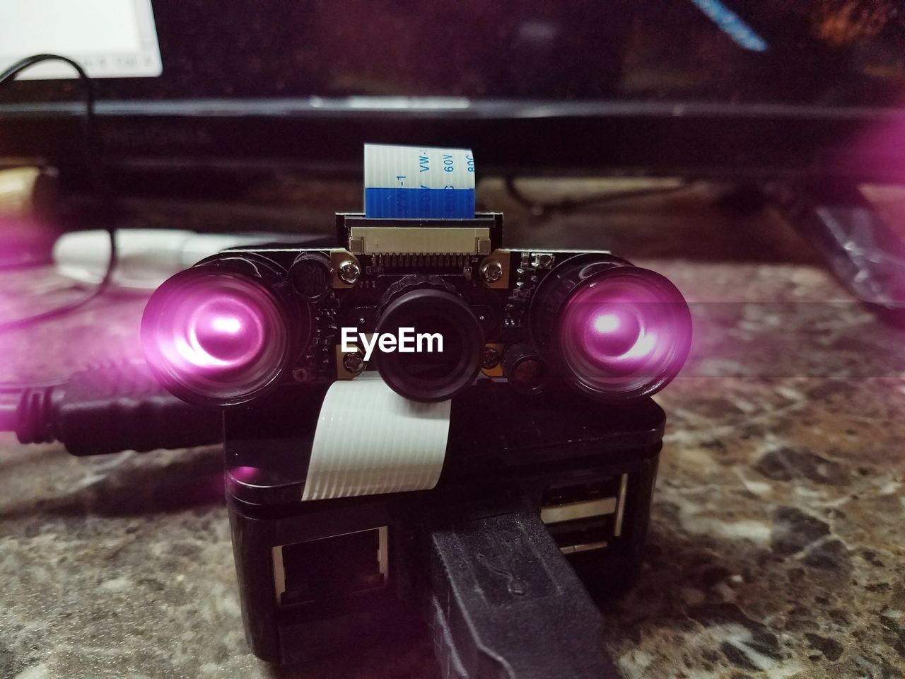 CLOSE-UP OF CAMERA ON TABLE AT HOME