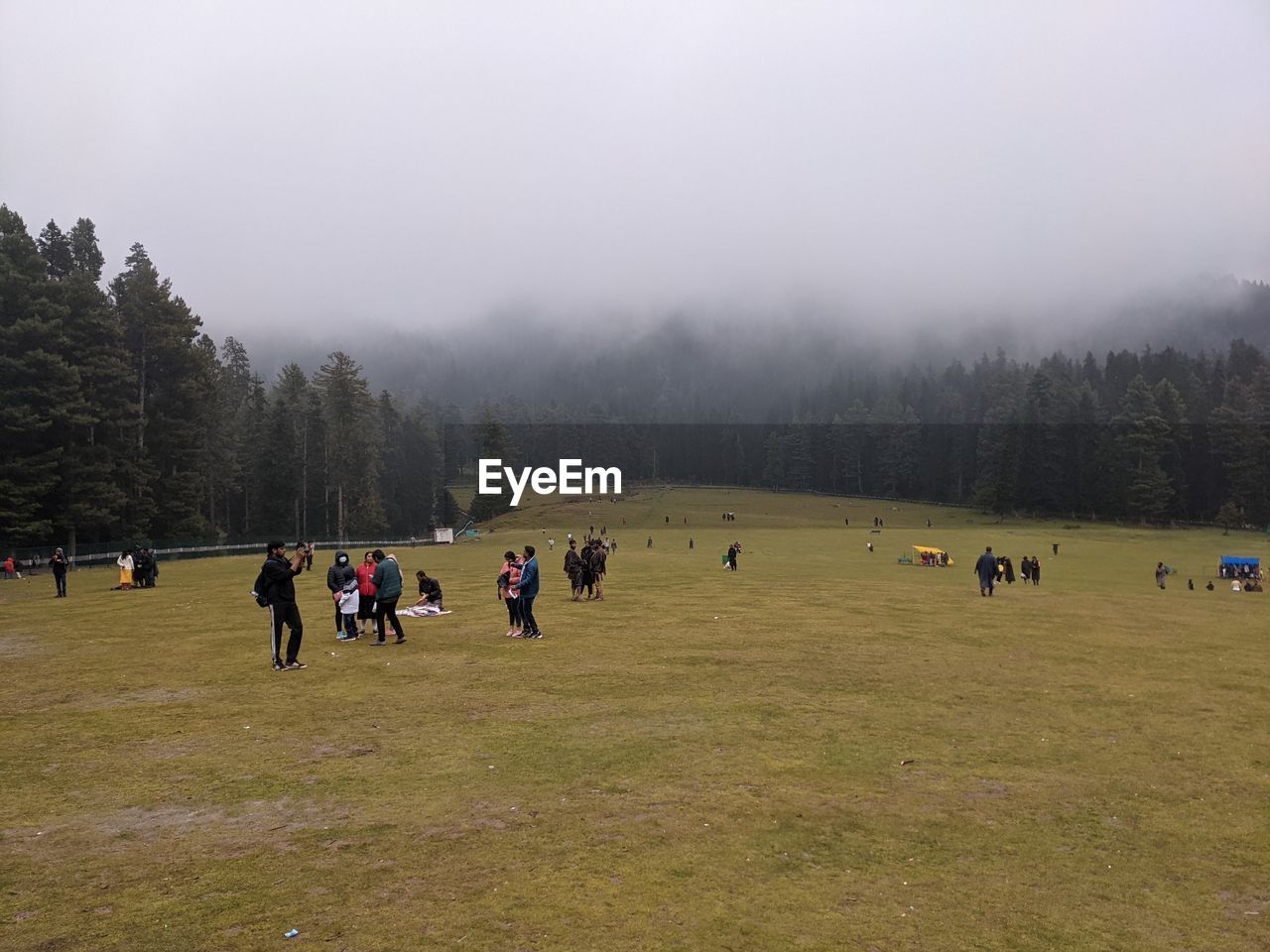 PEOPLE ON FIELD AGAINST SKY