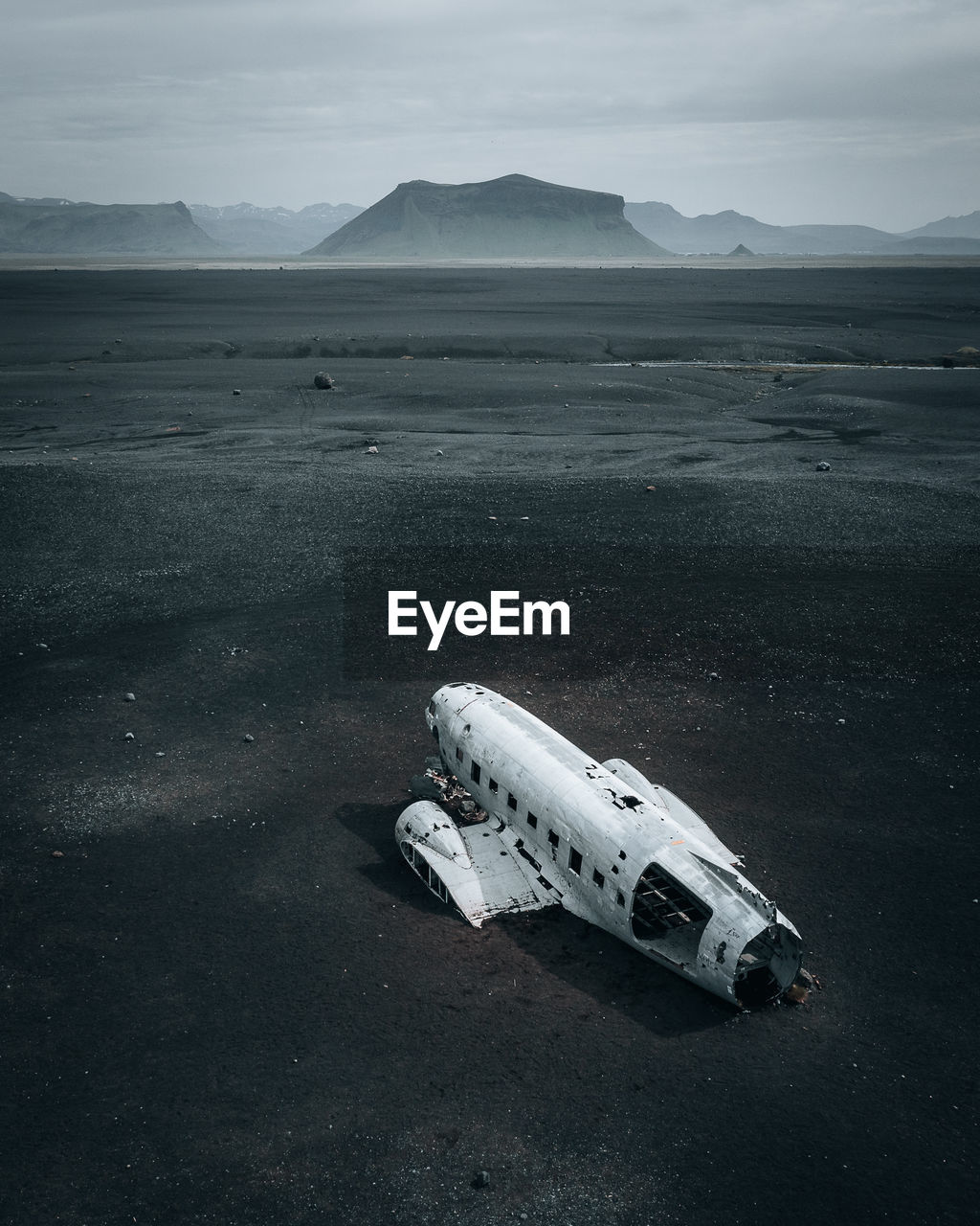 Cinematic aerial view of dc-3 airplane wreckage at black beach, sólheimasandur, iceland.