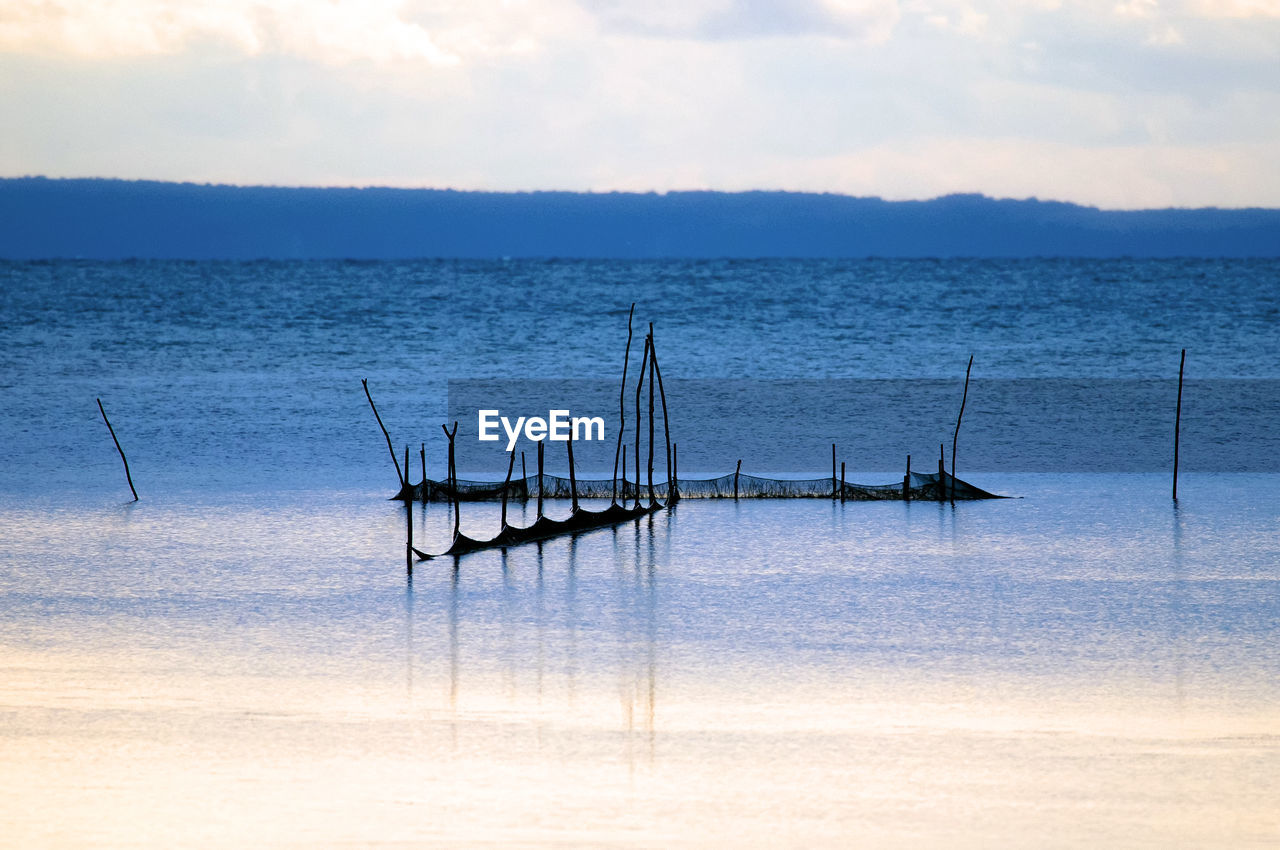 Scenic view of sea against sky at sunset