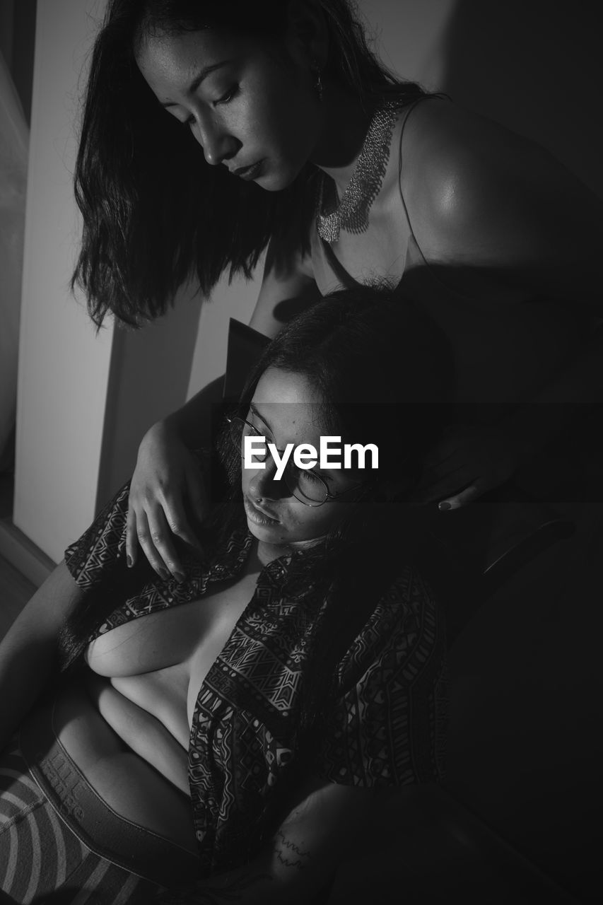 Lesbian couple sitting at home