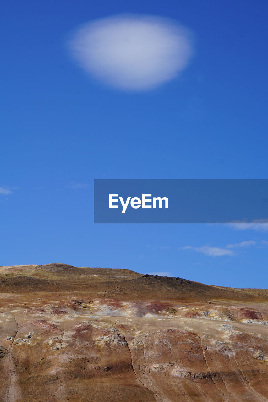 Scenic view of arid landscape against sky