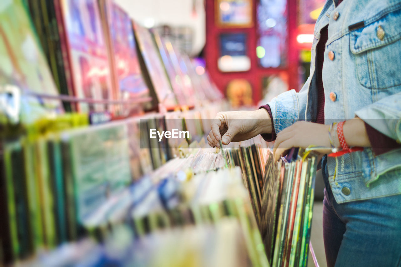 Woman holding books at market