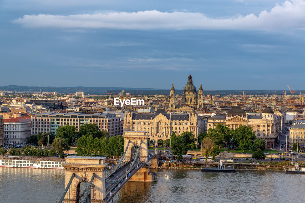 View of buildings in city against cloudy sky