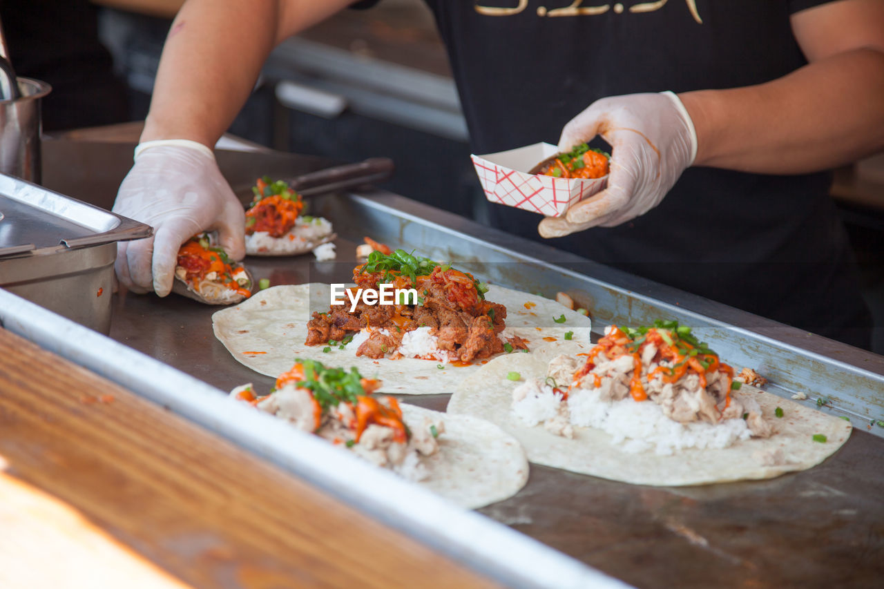 Midsection of man preparing food at restaurant