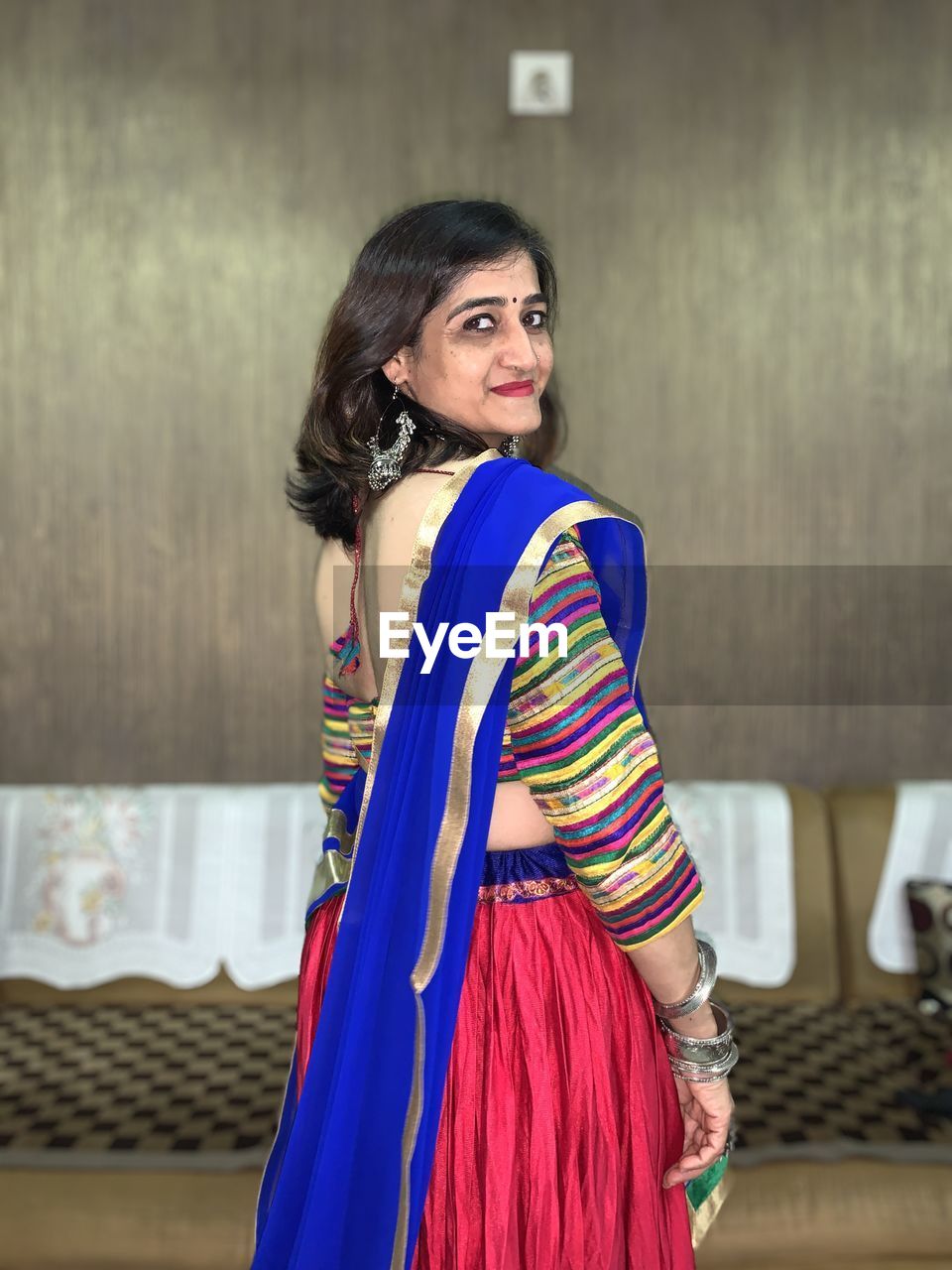 Portrait of woman wearing sari standing at home