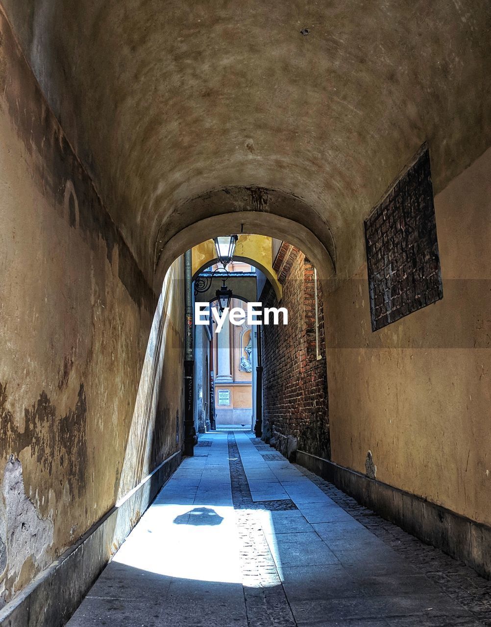 EMPTY CORRIDOR ALONG WALLS AND TUNNEL