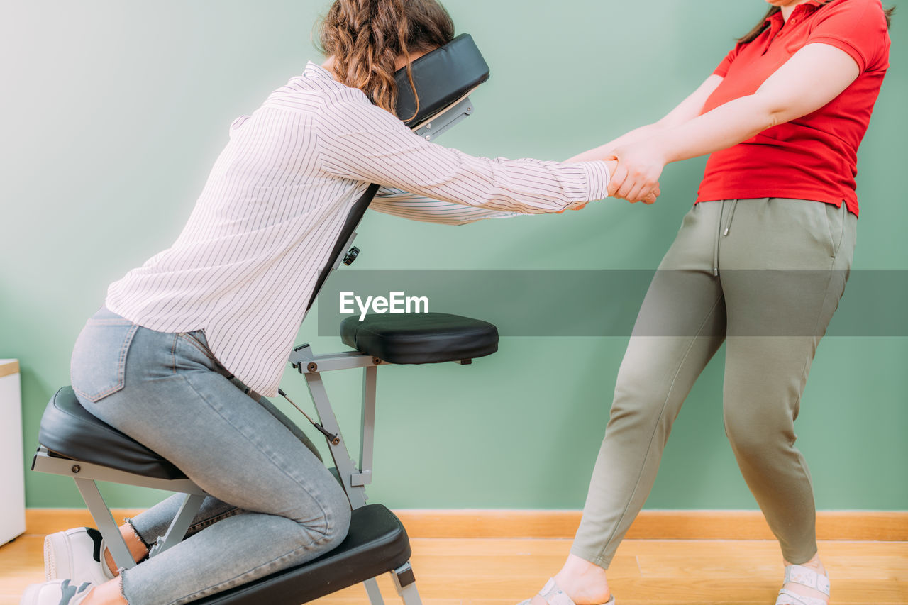 Corporate stress relief chair massage in the office. corporate female employee sitting 