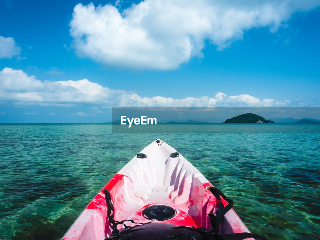 First person view of sea kayak with clear turquoise water and coral reef. koh mak island, thailand.
