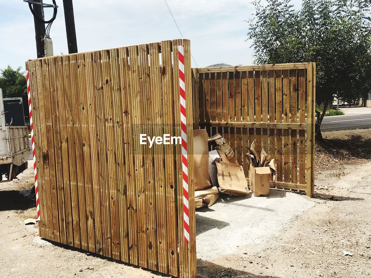 STACK OF WOODEN FENCE BY ROAD