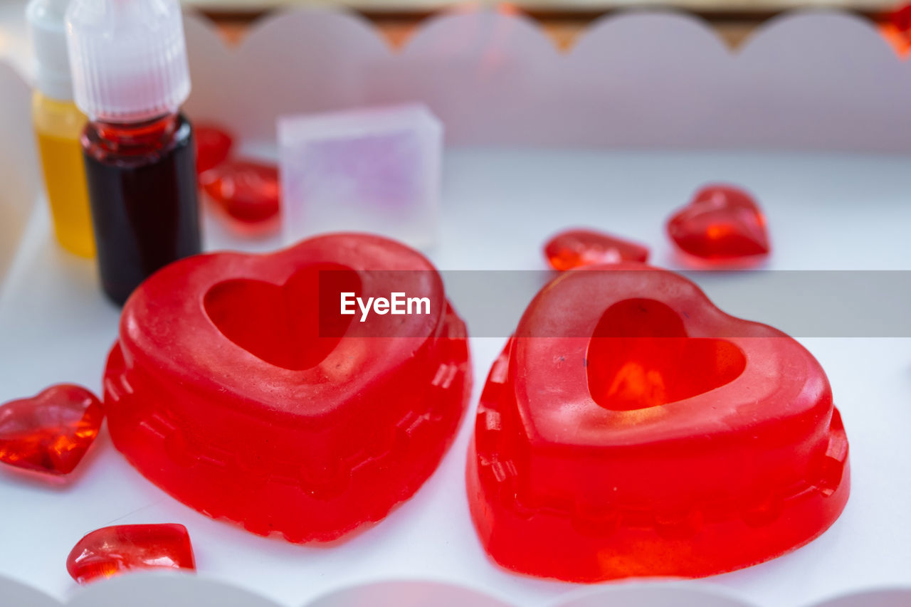 red, heart, food and drink, heart shape, food, love, positive emotion, valentine's day, lip, indoors, no people, sweet food, close-up, container, emotion, sweet, petal, healthcare and medicine, produce, bottle, pink, dessert