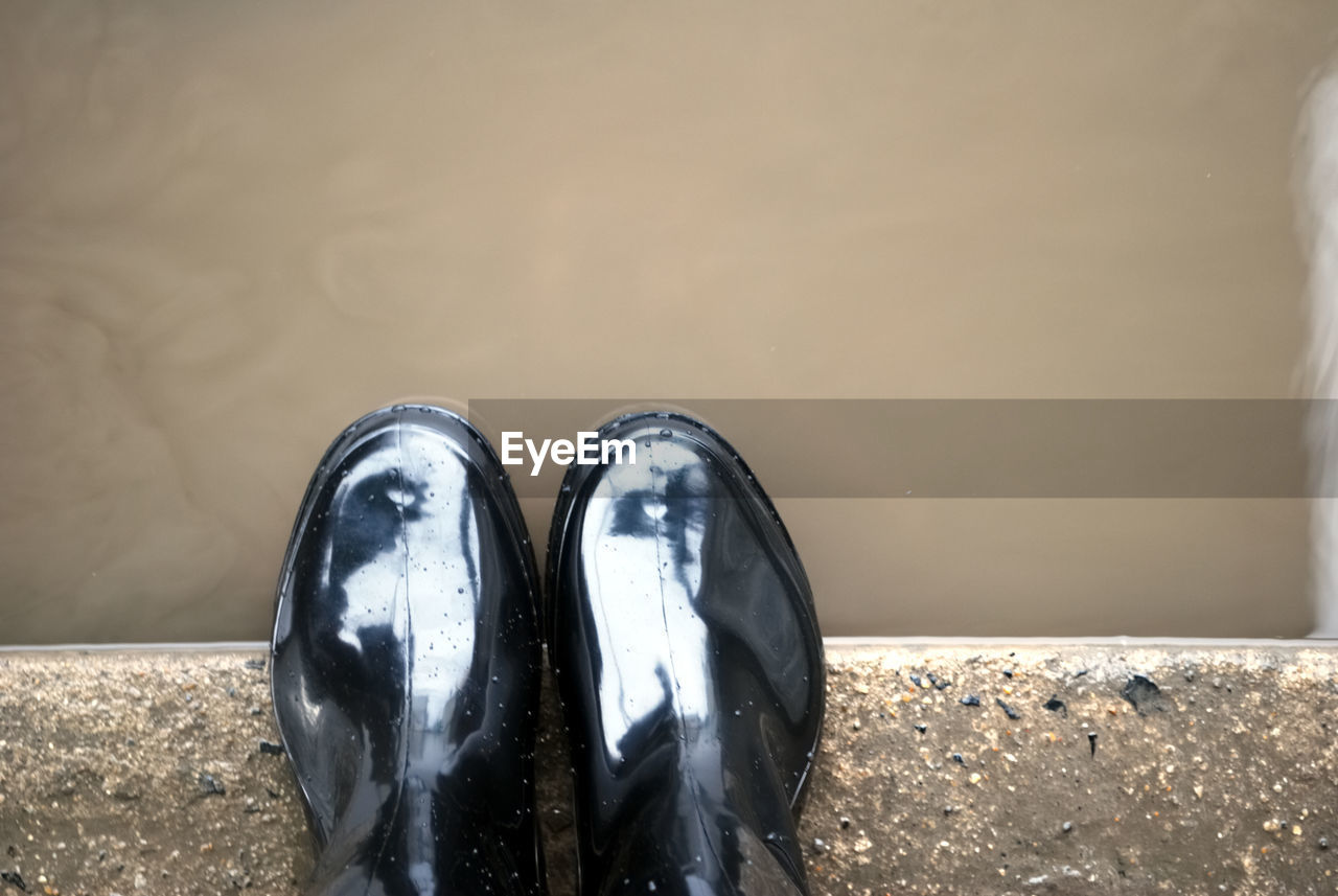 Directly above shot of shoes on retaining wall