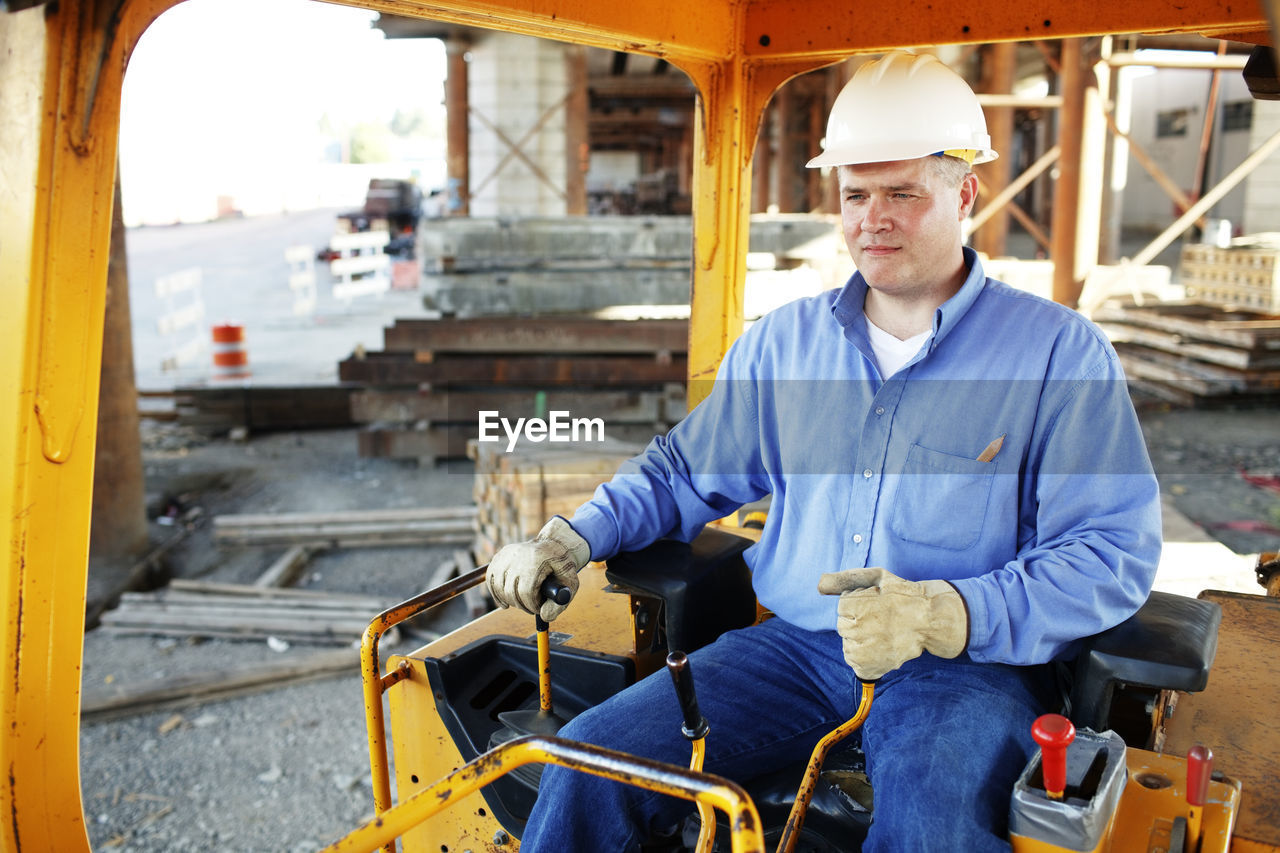 Male construction foreman sitting in a construction loarder