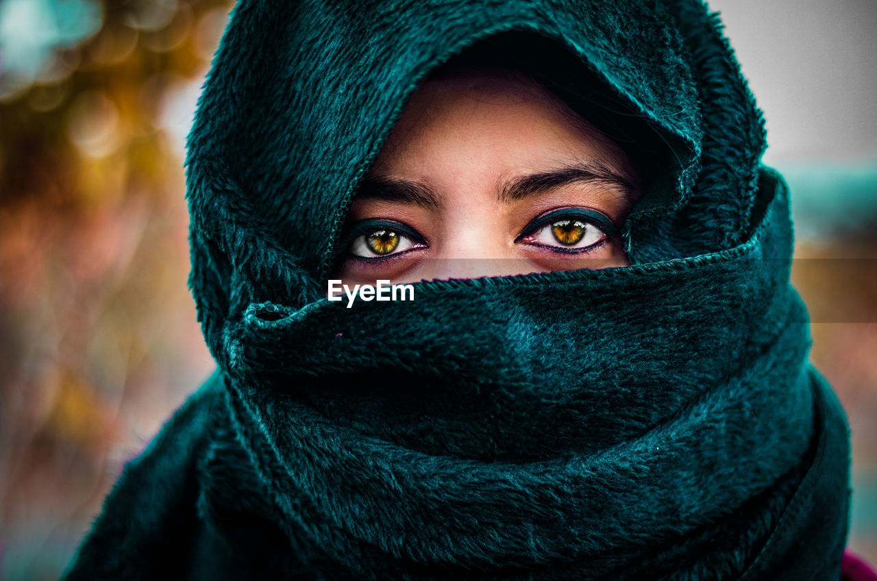 Close-up portrait of woman with face covered by scarf