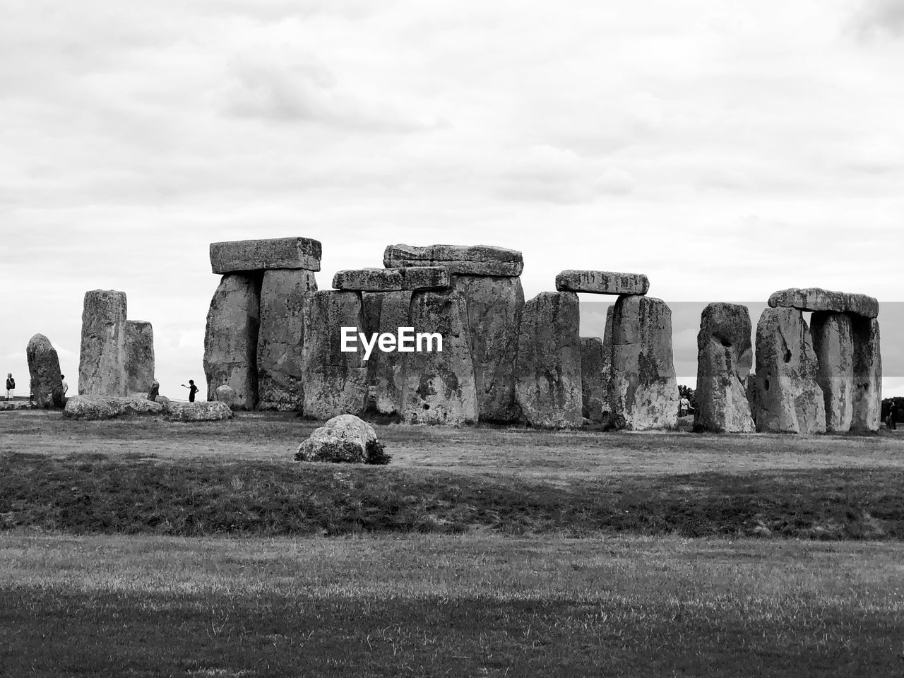  stonehenge on field against sky