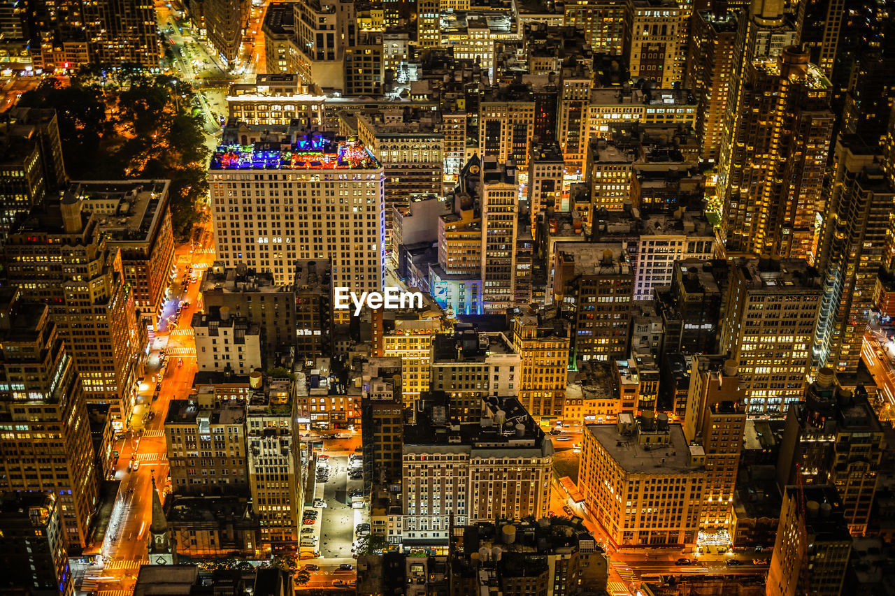 HIGH ANGLE VIEW OF ILLUMINATED CITY BUILDINGS