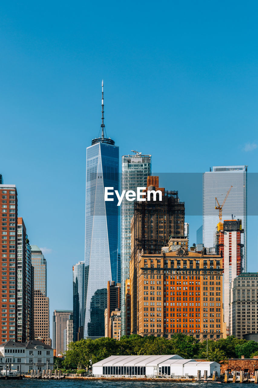 Modern buildings against clear blue sky