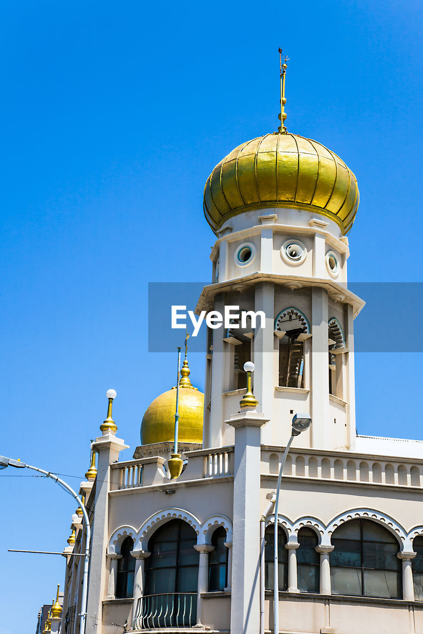 Low angle view of church against clear blue sky