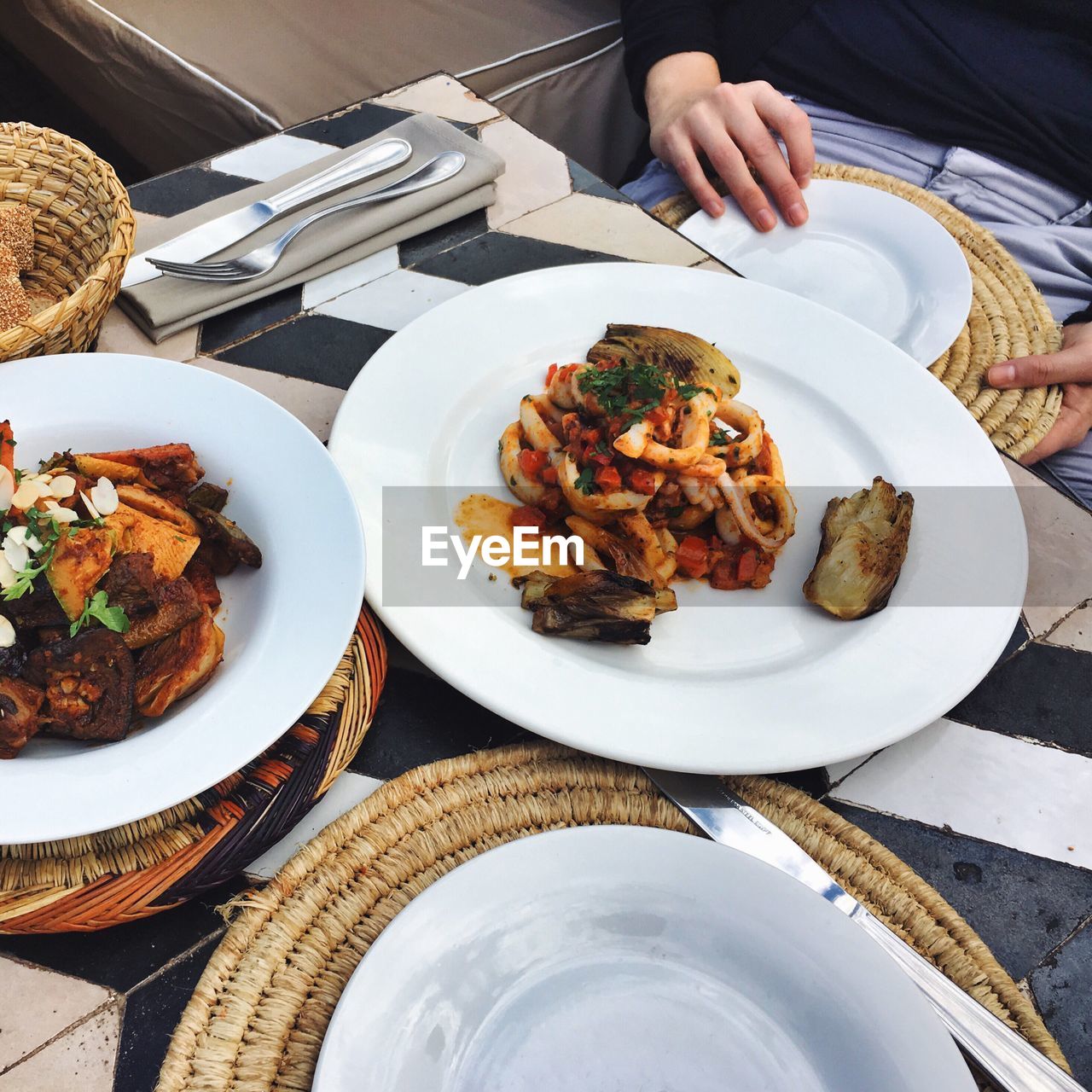 Midsection of woman having food in restaurant