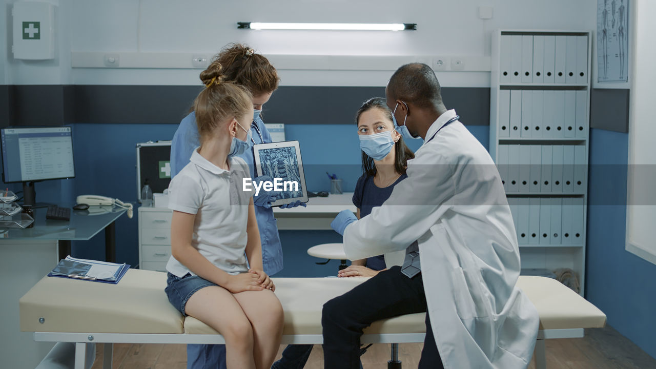 female doctor examining x-ray in clinic