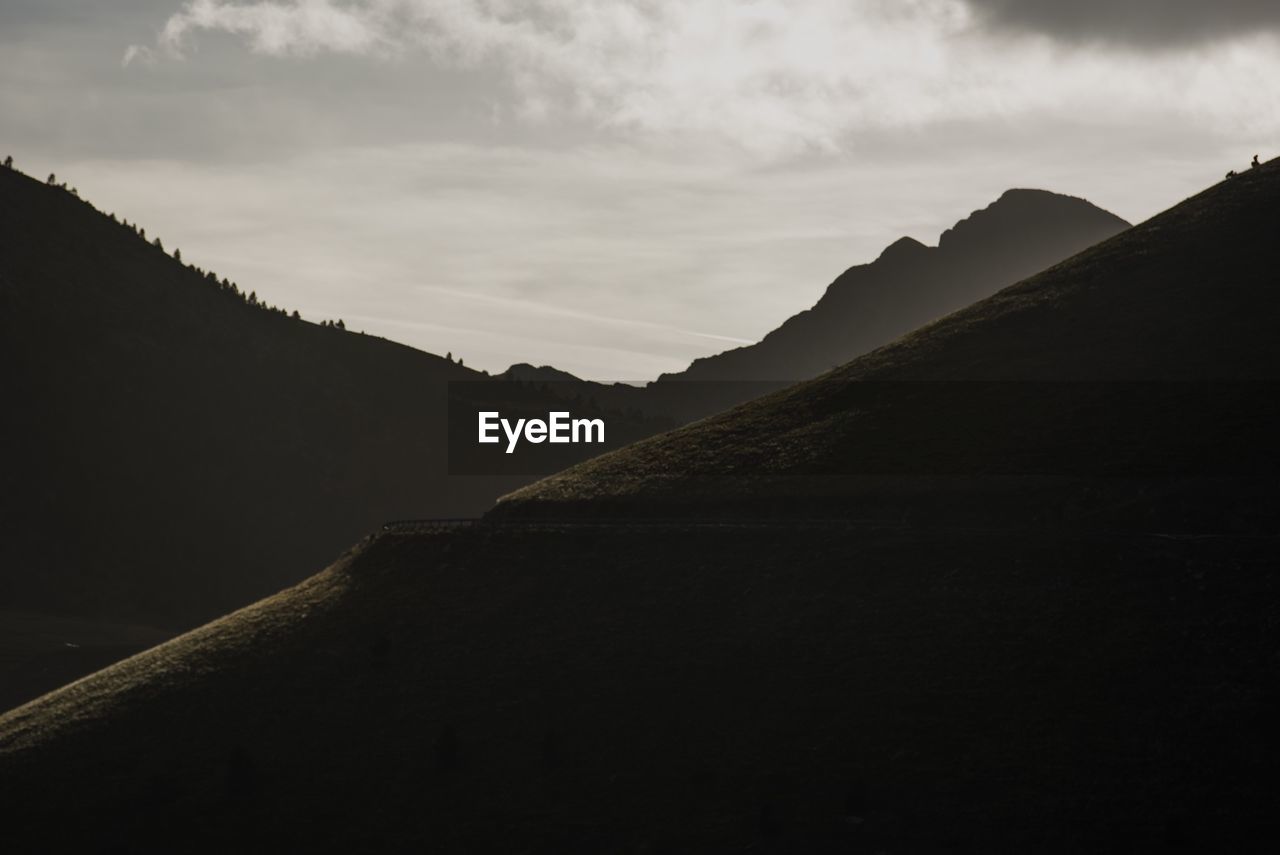 Scenic view of mountains against cloudy sky