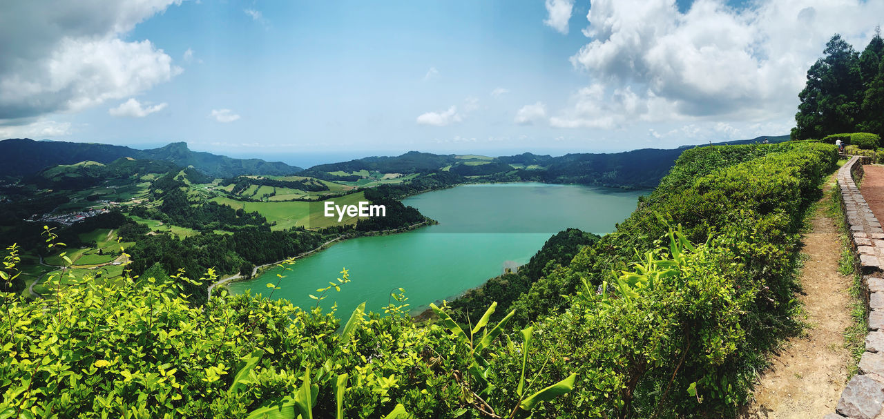 Panoramic view of green landscape against sky