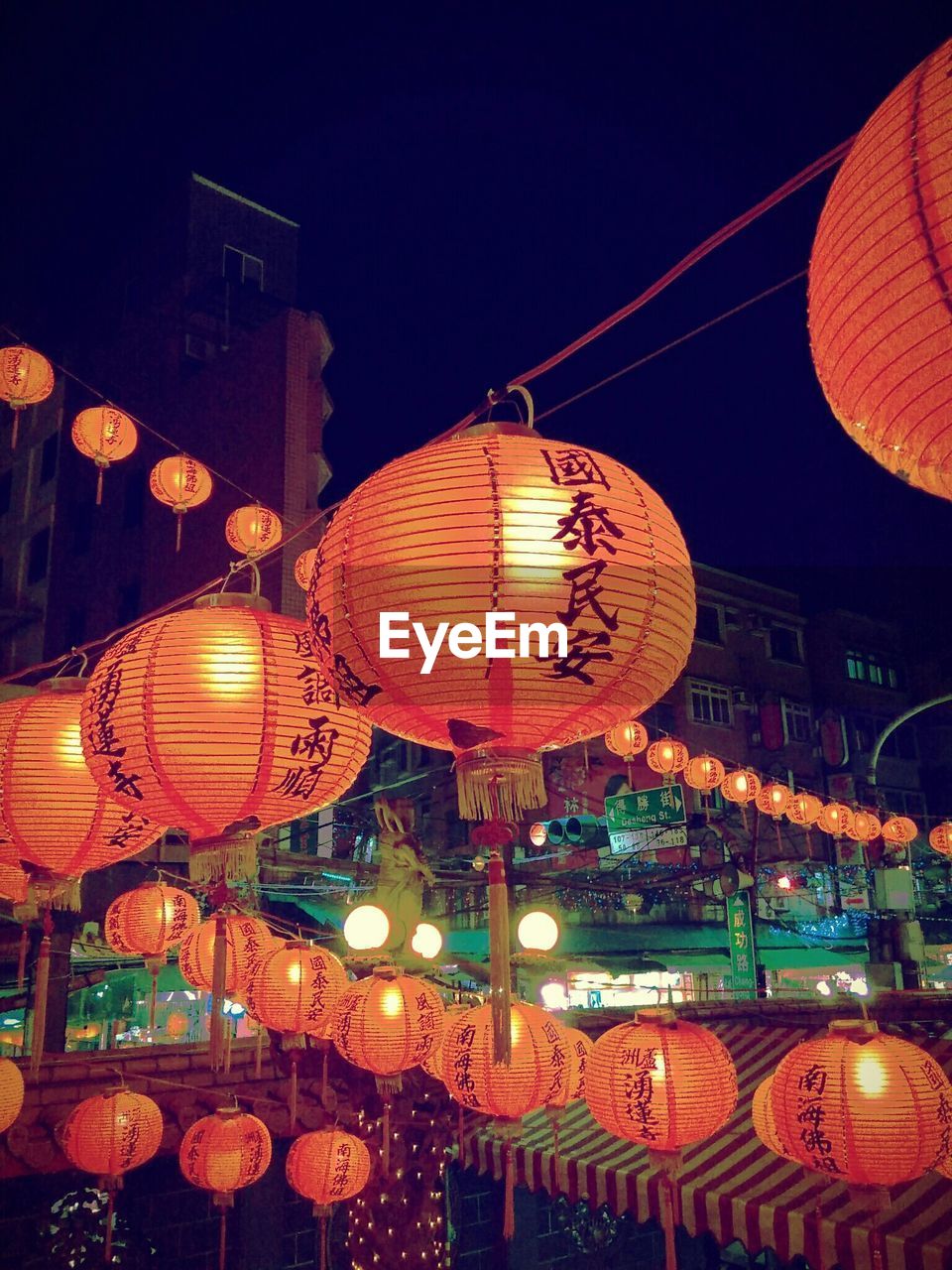 Illuminated chinese lanterns in city at night