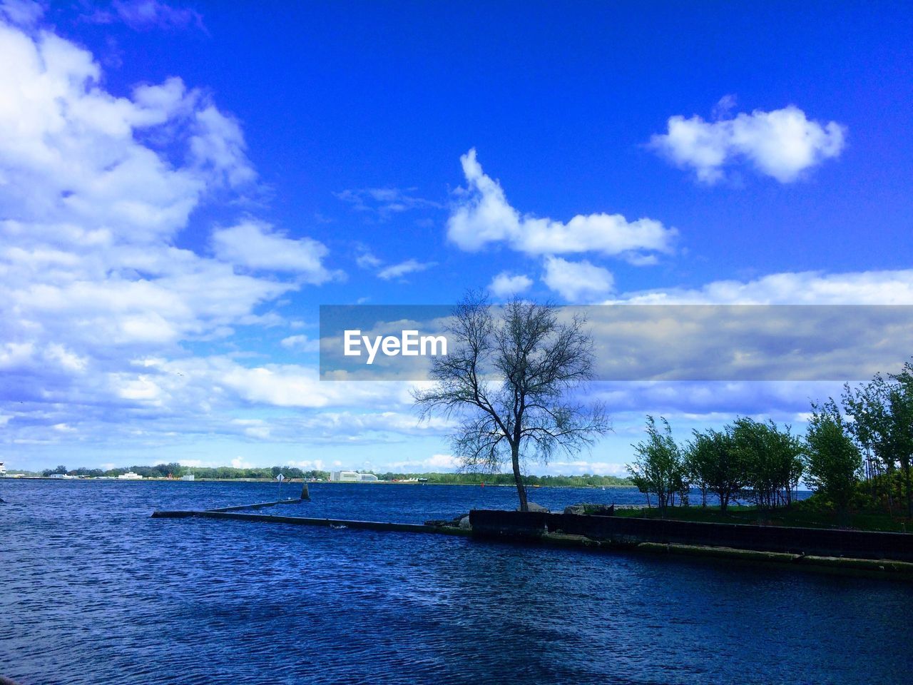 VIEW OF RIVER AGAINST CLOUDY SKY