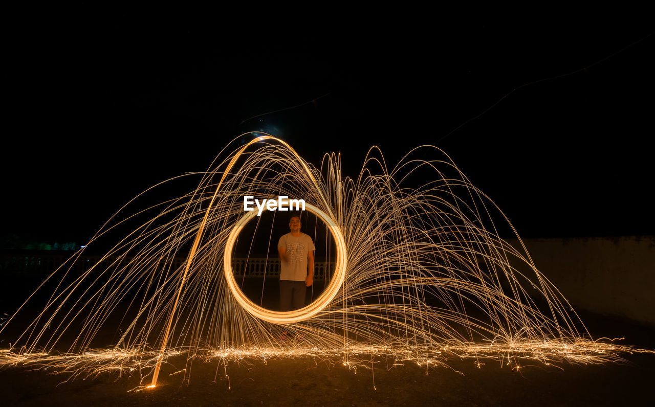 Light trails against sky at night