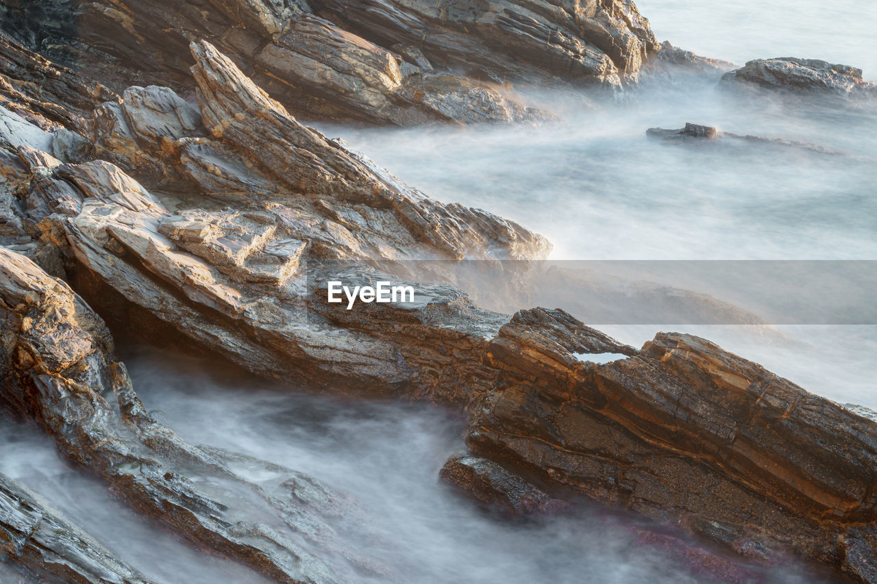 Scenic view of rocks against sea