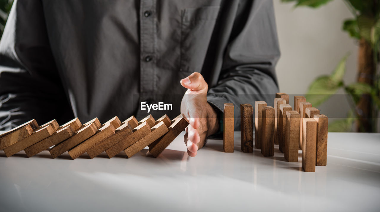 midsection of businessman playing chess at home