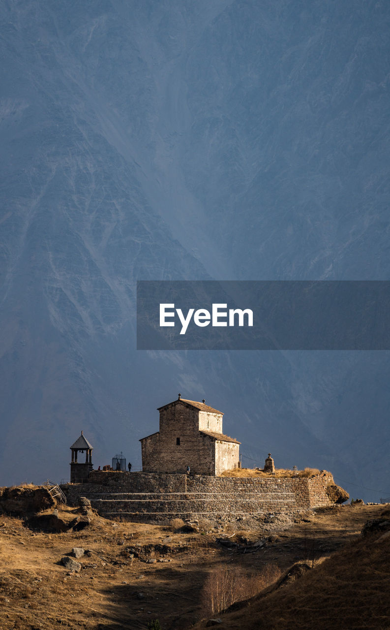 Buildings on mountain against sky